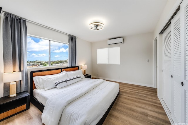 3795 Anuhea St, Honolulu, HI 96816 - bedroom with a wall mounted AC, a closet, and wood finished floors