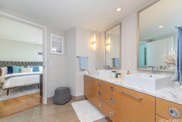 1177 Queen St Unit 3401, Honolulu, HI 96814 - bathroom featuring double vanity, connected bathroom, tile patterned floors, and recessed lighting