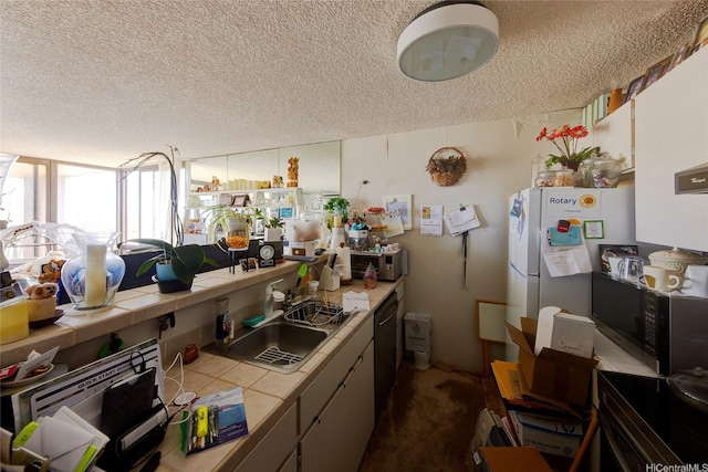 55 S Judd St Unit 2206, Honolulu, HI 96817 - kitchen with tile counters, black microwave, a textured ceiling, dishwashing machine, and dark carpet