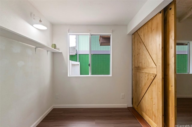 1482 Honokahua St, Honolulu, HI 96825 - unfurnished bedroom with a barn door and wood finished floors