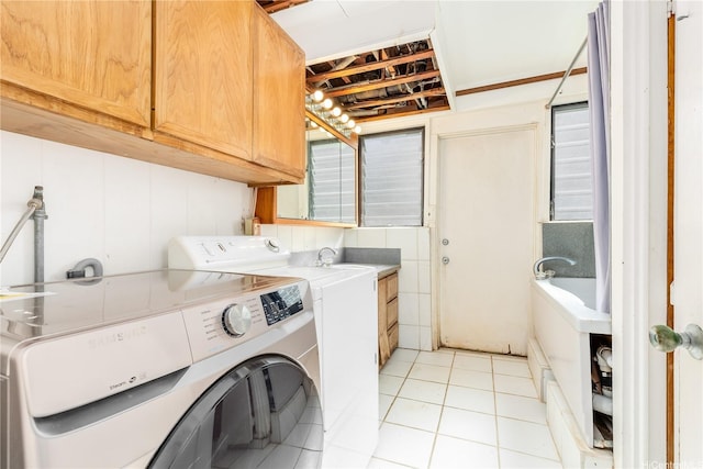 3038 Lanikaula St, Honolulu, HI 96822 - washroom featuring cabinet space, washer and clothes dryer, and light tile patterned flooring