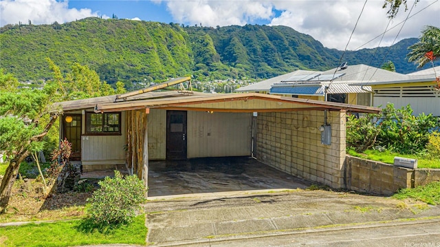 3038 Lanikaula St, Honolulu, HI 96822 - view of front of house featuring a mountain view, driveway, and a carport