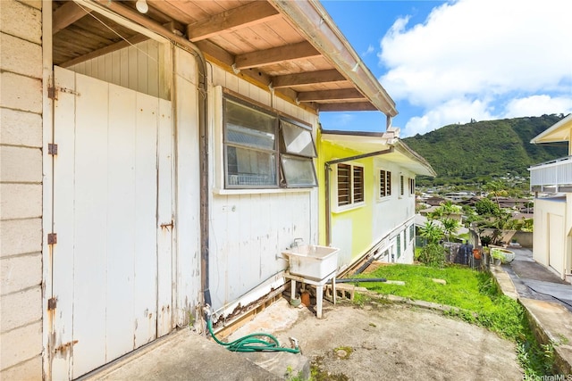 3038 Lanikaula St, Honolulu, HI 96822 - view of side of home with a mountain view and a sink