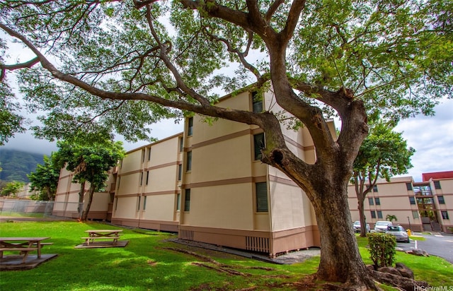 84-687 Ala Mahiku St Unit 120B, Waianae, HI 96792 - view of side of property featuring a yard and stucco siding