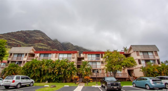 84-687 Ala Mahiku St Unit 120B, Waianae, HI 96792 - view of building exterior with uncovered parking, a mountain view, and stairs