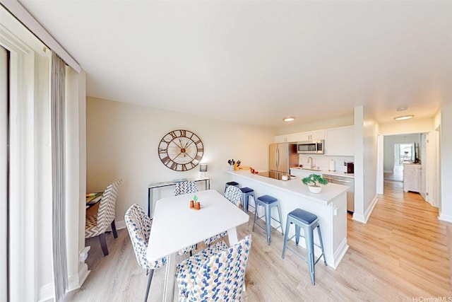 84-687 Ala Mahiku St Unit 120B, Waianae, HI 96792 - dining area with light wood-style floors and baseboards