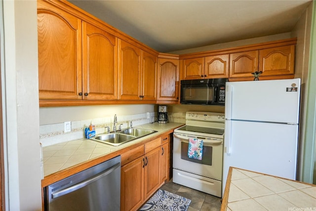 57-101 Kuilima Dr Unit 189, Kahuku, HI 96731 - kitchen featuring white appliances, tile counters, brown cabinets, and tile patterned floors