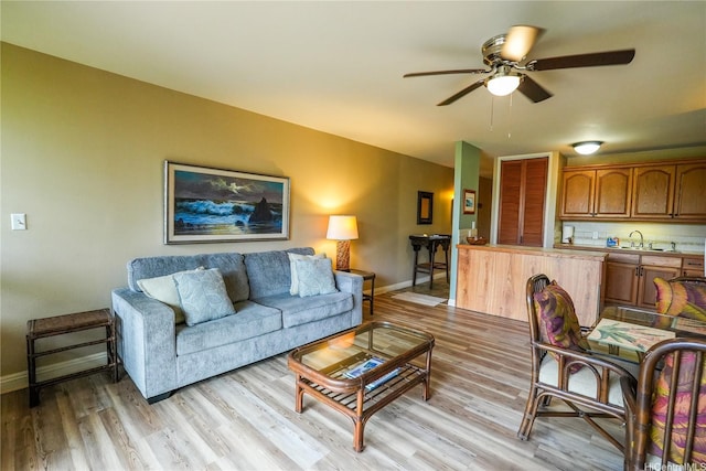 57-101 Kuilima Dr Unit 189, Kahuku, HI 96731 - living room featuring a ceiling fan and light wood-style flooring