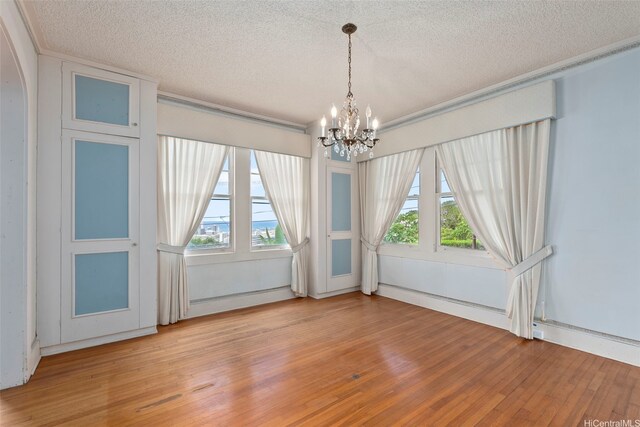 1186 Alewa Dr, Honolulu, HI 96817 - unfurnished room featuring a textured ceiling, a chandelier, light wood-type flooring, and ornamental molding
