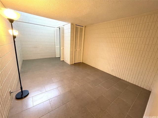 1720 Huna St Unit B102, Honolulu, HI 96817 - spare room with a textured ceiling and dark tile patterned flooring