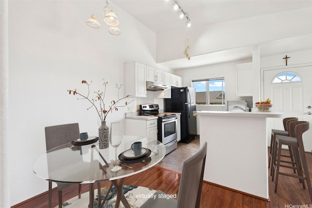94-510 Lumiaina St Unit J202, Waipahu, HI 96797 - kitchen with stainless steel range with electric stovetop, under cabinet range hood, a peninsula, light countertops, and white cabinets