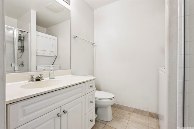 94-510 Lumiaina St Unit J202, Waipahu, HI 96797 - full bath with stacked washer and clothes dryer, vanity, an enclosed shower, and tile patterned flooring