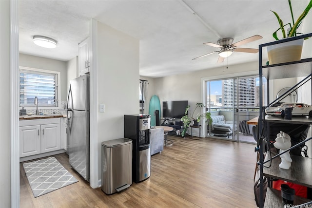 509 University Ave Unit 1001, Honolulu, HI 96826 - kitchen featuring freestanding refrigerator, white cabinetry, ceiling fan, and light wood-type flooring