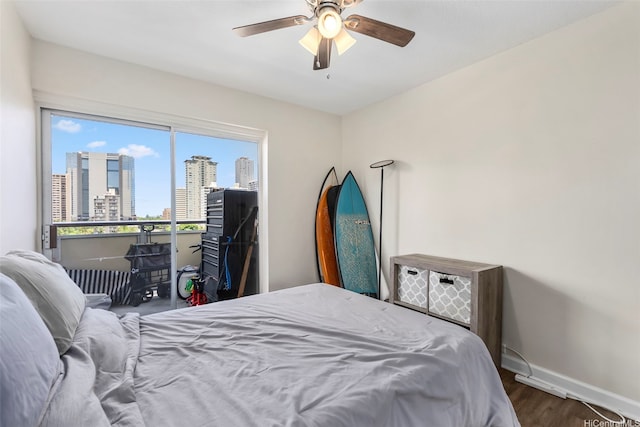 509 University Ave Unit 1001, Honolulu, HI 96826 - bedroom featuring wood finished floors, a view of skyline, and ceiling fan