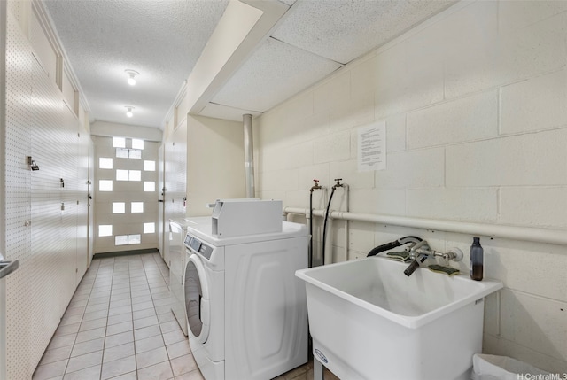 509 University Ave Unit 1001, Honolulu, HI 96826 - communal laundry room featuring concrete block wall, light tile patterned floors, and independent washer and dryer