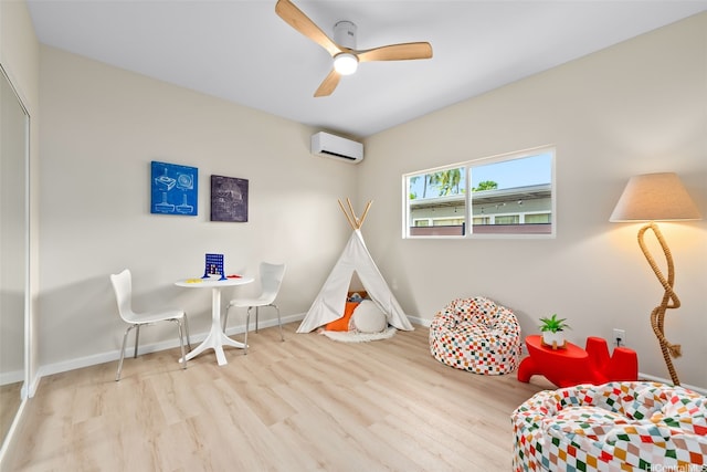 1076 Kahili St, Kailua, HI 96734 - rec room with a wall mounted air conditioner, wood finished floors, and ceiling fan