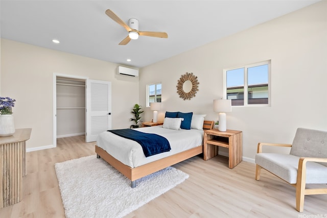 1076 Kahili St, Kailua, HI 96734 - bedroom featuring a wall mounted AC, light wood-style flooring, ceiling fan, a closet, and recessed lighting