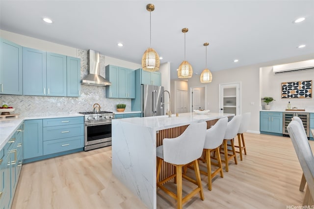 1076 Kahili St, Kailua, HI 96734 - kitchen featuring wall chimney exhaust hood, high quality appliances, beverage cooler, light wood-style floors, and tasteful backsplash