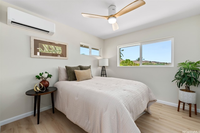 1076 Kahili St, Kailua, HI 96734 - bedroom with an AC wall unit, wood finished floors, and a ceiling fan