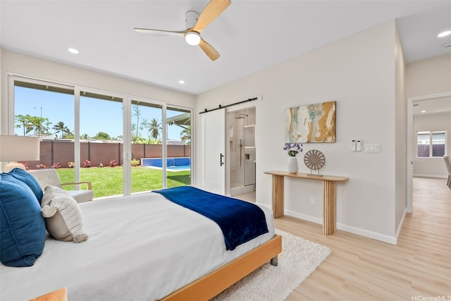 1076 Kahili St, Kailua, HI 96734 - bedroom with wood finished floors, a barn door, access to exterior, recessed lighting, and ceiling fan