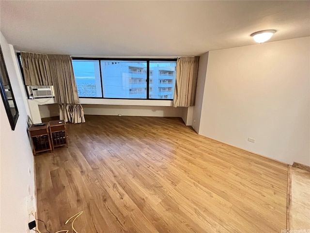 1700 Ala Moana Blvd Unit 1702, Honolulu, HI 96815 - unfurnished living room with wood finished floors and cooling unit