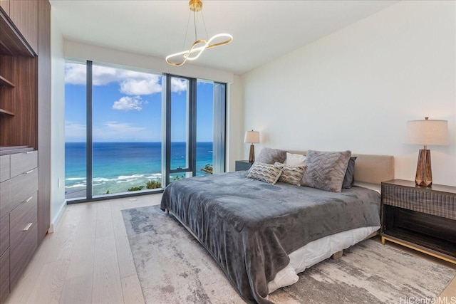 1100 Ala Moana Blvd Unit 3600, Honolulu, HI 96814 - bedroom featuring light wood-type flooring, a chandelier, multiple windows, and access to exterior