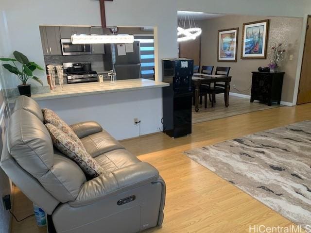 3395 Hardesty St, Honolulu, HI 96816 - living area featuring light wood-style floors and a chandelier