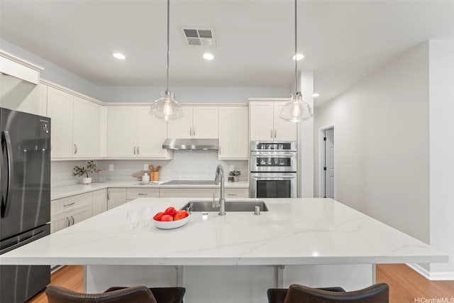 520 Lunalilo Home Rd Unit 208, Honolulu, HI 96825 - kitchen featuring freestanding refrigerator, stainless steel double oven, a breakfast bar, recessed lighting, and pendant lighting