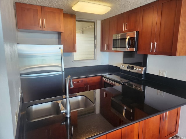 98-099 Uao Pl Unit Ph5, Aiea, HI 96701 - kitchen featuring stainless steel appliances, a textured ceiling, and brown cabinetry