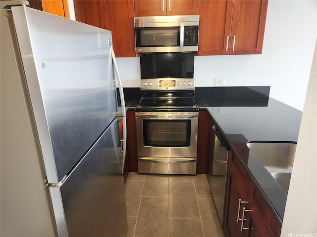 98-099 Uao Pl Unit Ph5, Aiea, HI 96701 - kitchen with stainless steel appliances, tile patterned floors, and brown cabinetry