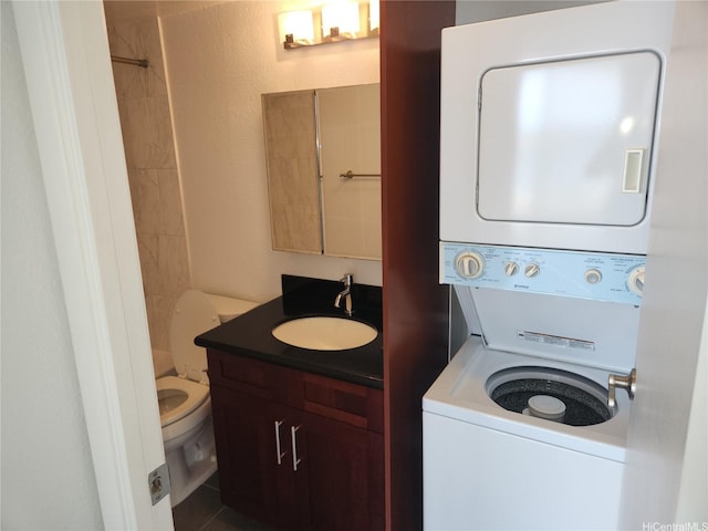98-099 Uao Pl Unit Ph5, Aiea, HI 96701 - washroom with stacked washer / dryer and dark tile patterned floors