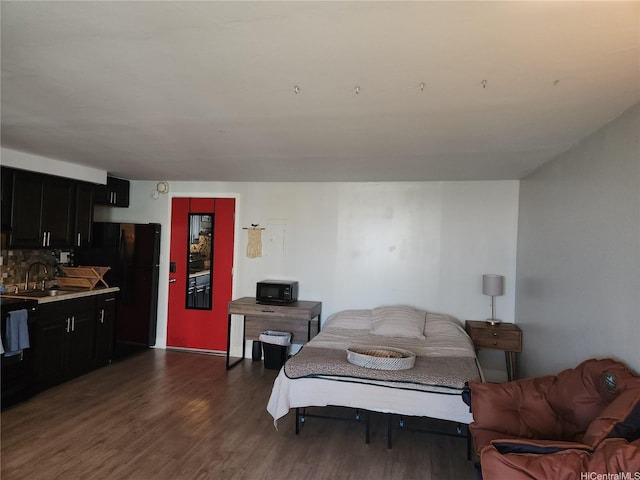 824 Kinau St Unit 403, Honolulu, HI 96813 - bedroom with freestanding refrigerator and dark wood-style floors