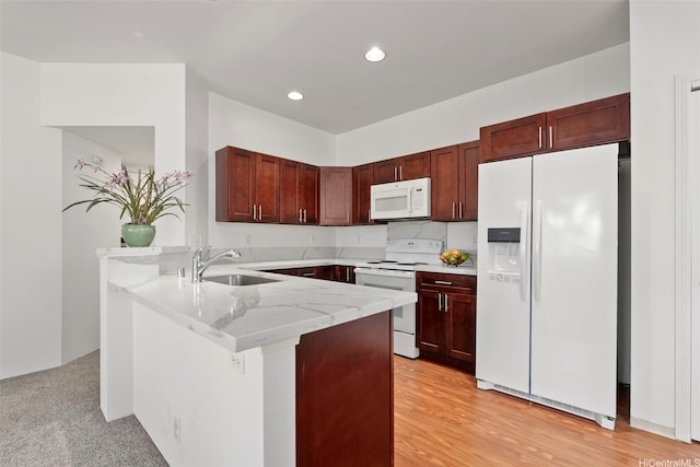 91-1001 Keaunui Dr Unit 97, Ewa Beach, HI 96706 - kitchen with white appliances, a peninsula, light stone countertops, recessed lighting, and dark brown cabinets