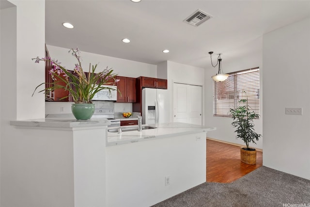 91-1001 Keaunui Dr Unit 97, Ewa Beach, HI 96706 - kitchen featuring white appliances, carpet, recessed lighting, a peninsula, and decorative light fixtures