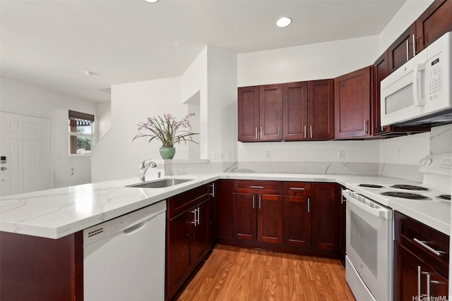 91-1001 Keaunui Dr Unit 97, Ewa Beach, HI 96706 - kitchen featuring white appliances, dark brown cabinets, a peninsula, light wood-type flooring, and light stone countertops