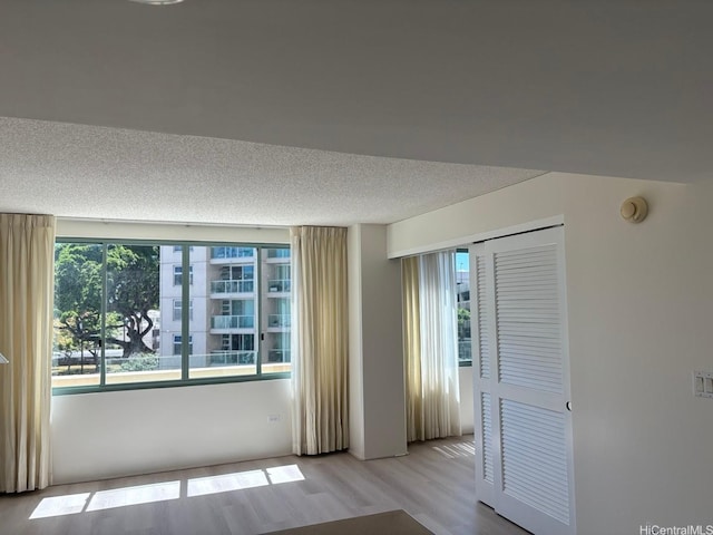1314 Kalakaua Ave Unit 304, Honolulu, HI 96826 - unfurnished room with a textured ceiling, wood finished floors, and a smoke detector