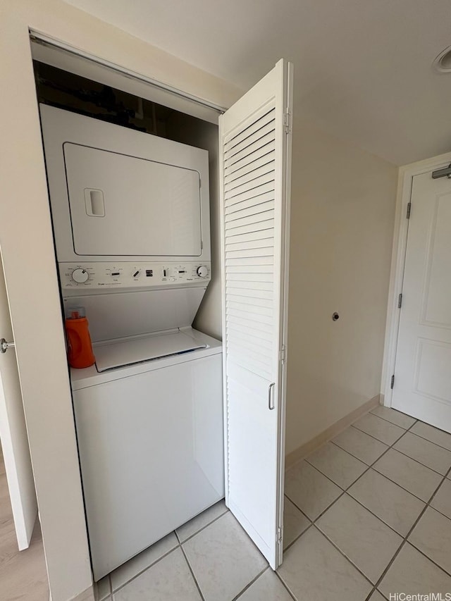 1314 Kalakaua Ave Unit 304, Honolulu, HI 96826 - washroom with stacked washer / drying machine and light tile patterned flooring