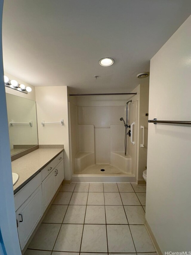 1314 Kalakaua Ave Unit 304, Honolulu, HI 96826 - bathroom featuring tile patterned floors, vanity, a stall shower, and recessed lighting