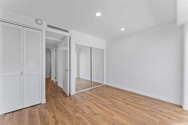 700 Richards St Unit 1709, Honolulu, HI 96813 - unfurnished bedroom with two closets, light wood finished floors, and recessed lighting