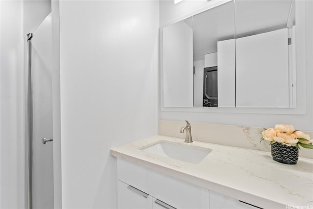 700 Richards St Unit 1709, Honolulu, HI 96813 - bathroom featuring vanity and estacked washer and dryer