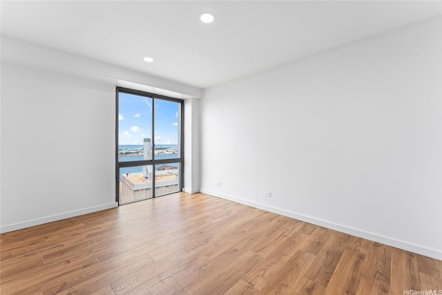 700 Richards St Unit 1709, Honolulu, HI 96813 - unfurnished room featuring light wood finished floors, a water view, and recessed lighting