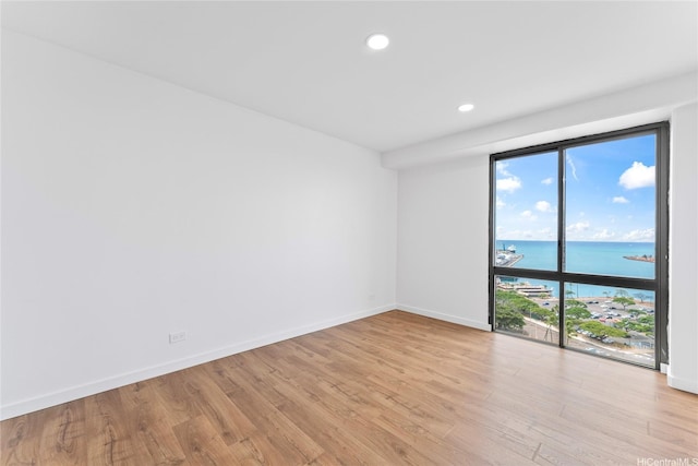 700 Richards St Unit 1709, Honolulu, HI 96813 - unfurnished room with a water view, light wood-type flooring, and recessed lighting