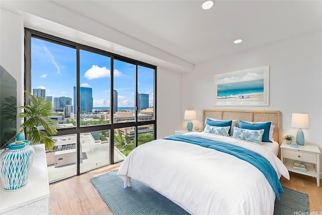 700 Richards St Unit 1709, Honolulu, HI 96813 - bedroom with wood finished floors, a skyline view, recessed lighting, and access to exterior