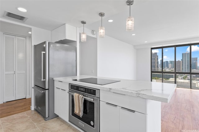 700 Richards St Unit 1709, Honolulu, HI 96813 - kitchen with appliances with stainless steel finishes, white cabinetry, light stone counters, pendant lighting, and modern cabinets