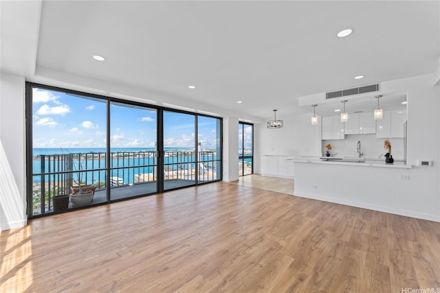 700 Richards St Unit 1709, Honolulu, HI 96813 - unfurnished living room with light wood-style floors, a water view, floor to ceiling windows, and recessed lighting
