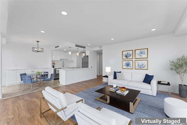 700 Richards St Unit 1709, Honolulu, HI 96813 - living area with light wood-style flooring, a chandelier, and recessed lighting