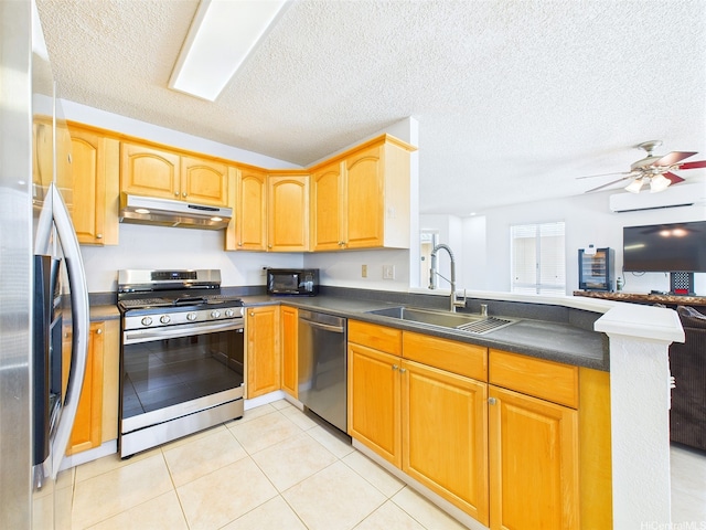 91-2037 Pahuhu Pl, Ewa Beach, HI 96706 - kitchen with appliances with stainless steel finishes, under cabinet range hood, dark countertops, a peninsula, and open floor plan