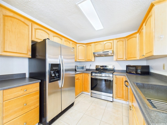 91-2037 Pahuhu Pl, Ewa Beach, HI 96706 - kitchen with stainless steel appliances, under cabinet range hood, dark countertops, a textured ceiling, and light tile patterned floors