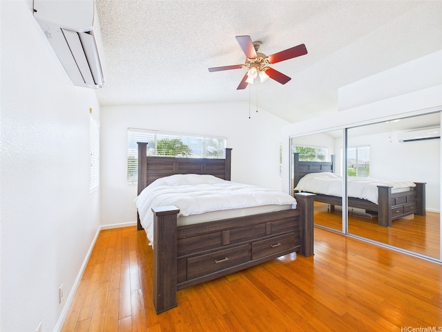 91-2037 Pahuhu Pl, Ewa Beach, HI 96706 - bedroom with a wall unit AC, light wood-style flooring, lofted ceiling, ceiling fan, and a closet
