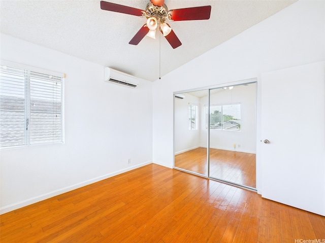 91-2037 Pahuhu Pl, Ewa Beach, HI 96706 - unfurnished bedroom featuring a wall mounted air conditioner, a closet, light wood-style floors, lofted ceiling, and ceiling fan